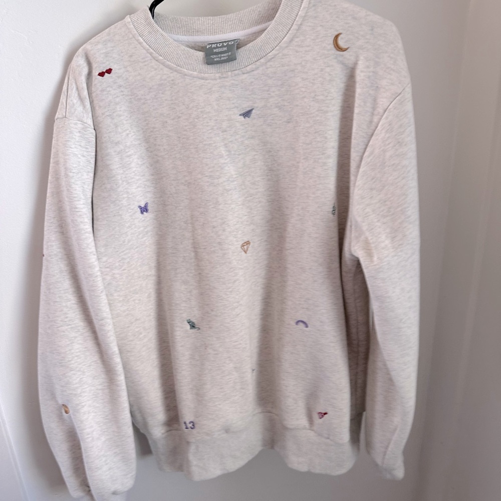 Taylor Swift embroidered sweatshirt has cute emblems from different eras/albums